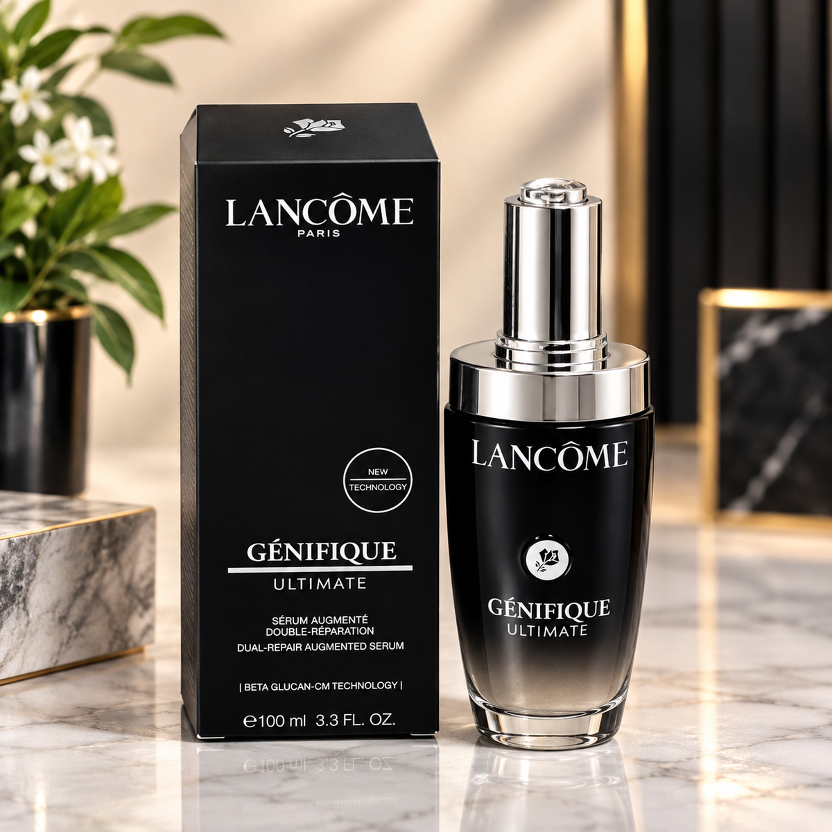 Lancôme Génifique Ultimate serum bottle and matching black box displayed on a marble surface with decorative plants and framed art in the background.